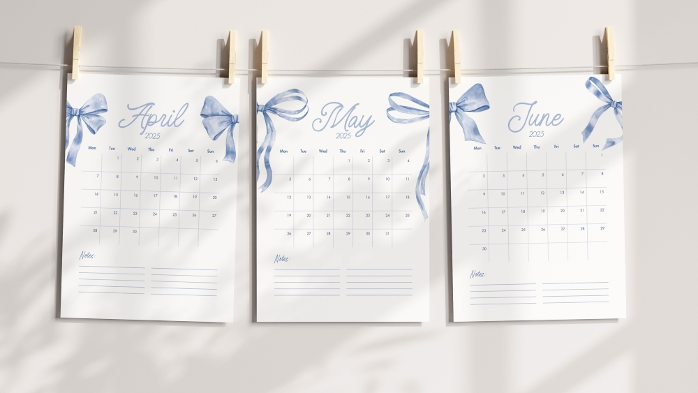 Three printable 2025 monthly calendar pages for April, May, and June featuring a blue coquette aesthetic with ribbon and bow illustrations, hanging on a line with wooden pegs.
