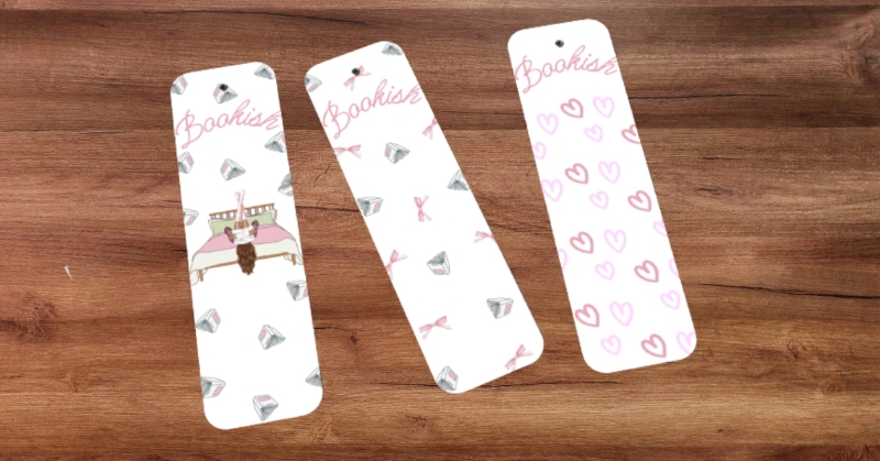 Three coquette bookmarks laid out on a wooden background.