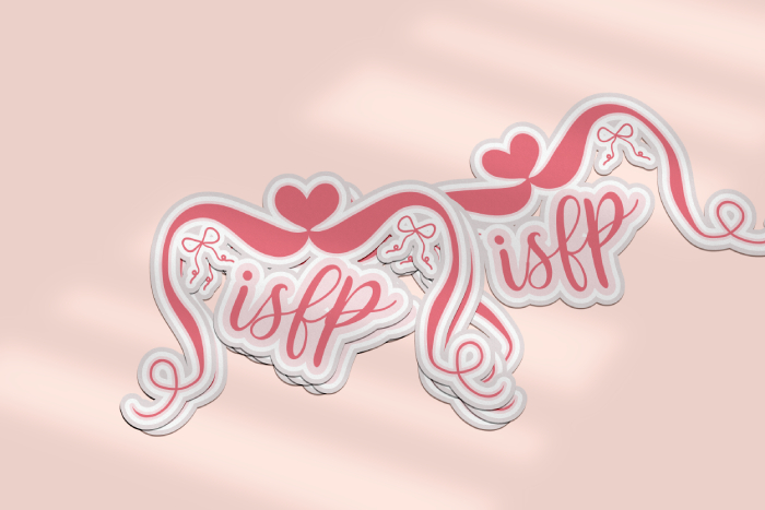 A mockup of an ISFP sticker showing a stack of three stickers in the foreground, with a single sticker cast off to the side behind them. The design is a pink coquette aesthetic with script lettering, a heart, and bows.
