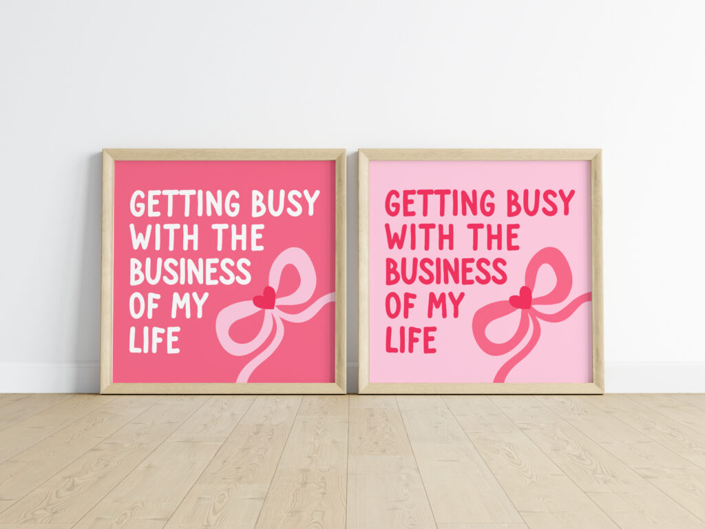 A mockup of two framed art prints with the quote 'Getting Busy With the Business of My Life' and a large pink bow. The left version has a dark pink background, while the right version has a light pink background.