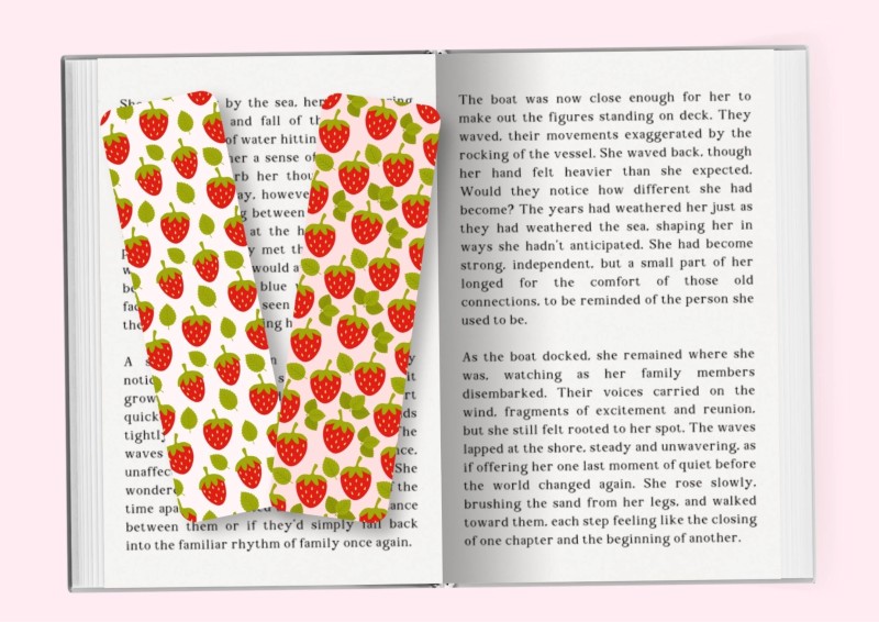 An open book with two strawberry themed bookmarks on the left hand side page